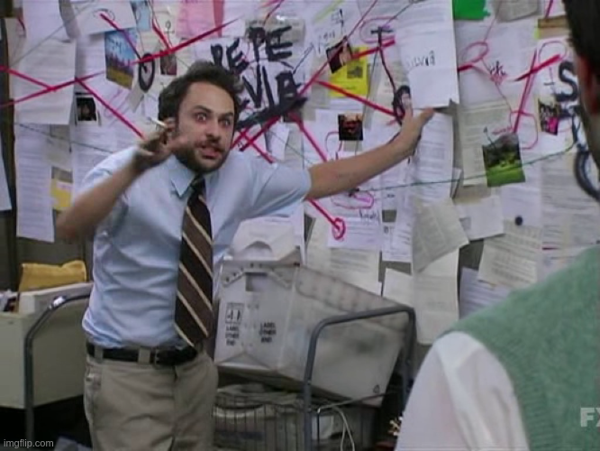 A screenshot from the TV show 'It's Always Sunny in Philadelphia' featuring the character Charlie Kelly looking manic and stressed. He is standing in front of a wall covered in papers and mail connected by a chaotic web of red string. He wears a light blue shirt and striped tie, gesturing wildly with one hand while holding a cigarette, appearing to frantically explain a conspiracy theory to someone off-camera.